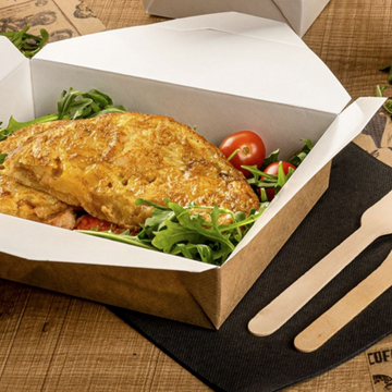 Scatola di cartoncino avana aperta con dentro polo corro su tavola con tovagliolo di carta e forchettine di legno monouso